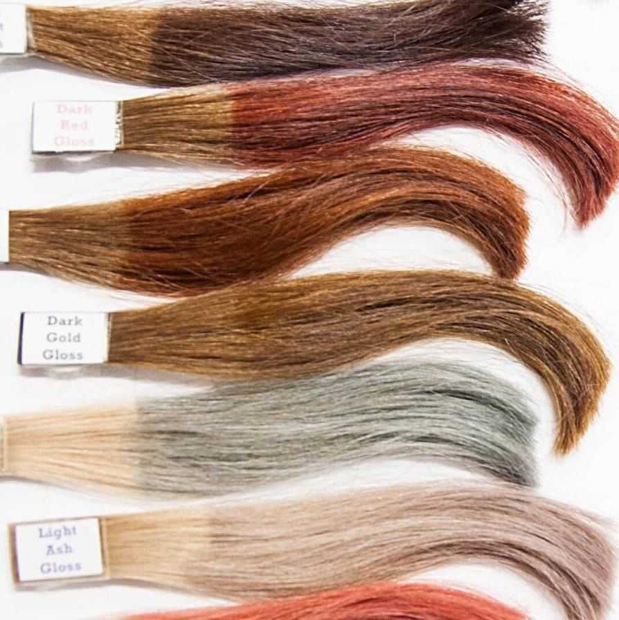 Sample of six hair swatches in varying shades of red, gold, and ash on a white background.